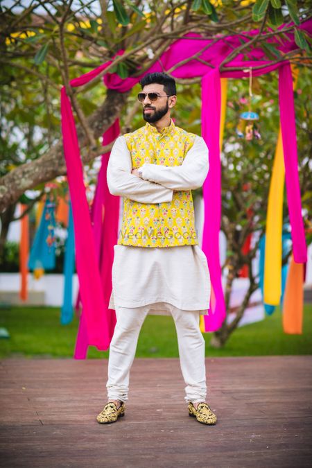 Quirky mehendi groomwear with yellow jacket over kurta 