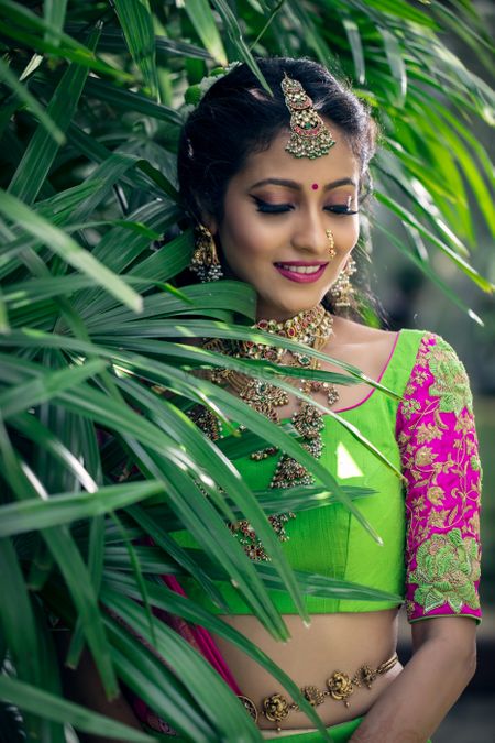 Bride in green and pink lehenga with embroidered sleeves 