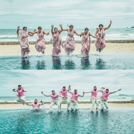 Matching bridesmaids and groomsmen jumping in water 