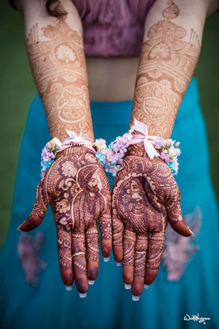Bridal mehendi with bride and groom portraits made on it