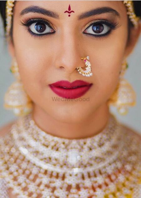 Photo of Dewy finish with matte red lisptick makeup for a south indian bride