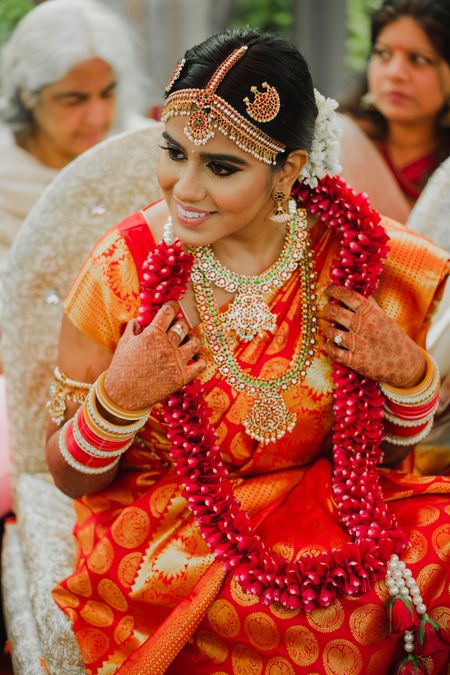 South Indian bride in orange saree