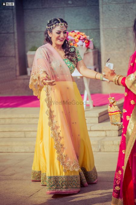 Mehendi bridal look with yellow and green lehenga 