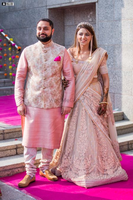 Matching bride and groom on mehendi in pastels 