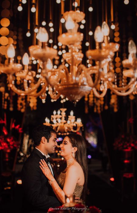 Photo of Couple shot on sangeet with chandelier