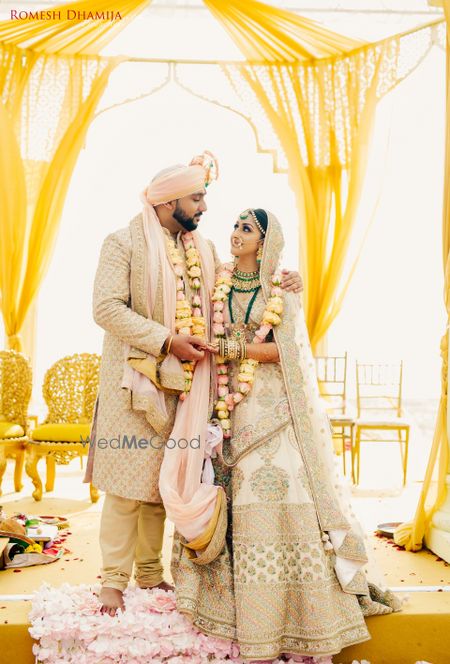 Matching bride and groom in ivory outfits 