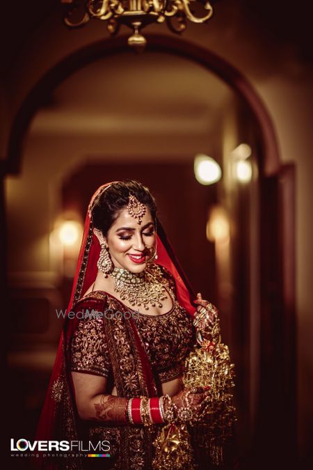 Happy bride in maroon embellished lehenga 