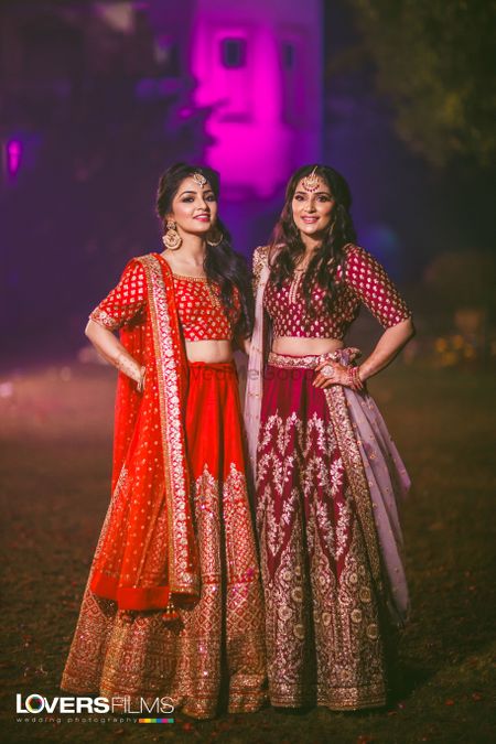 Sisters of the bride in red and maroon lehengas 