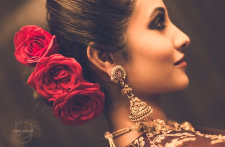 Photo of Bridal bun with roses for sangeet