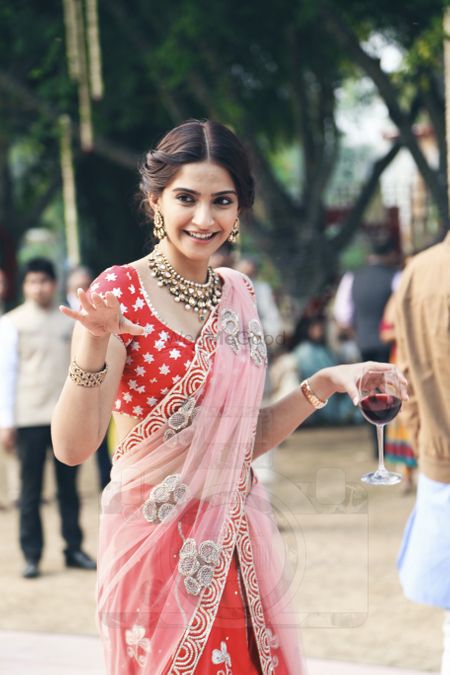 Photo of Sonam kapoor at wedding in red and pink lehenga