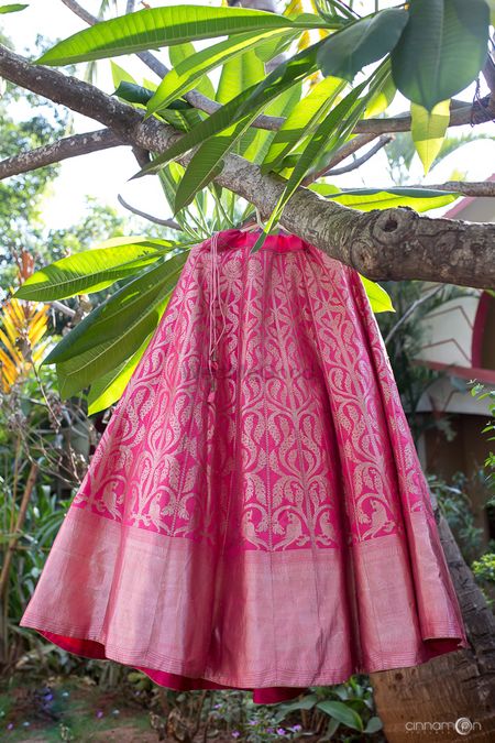 Bright pink benarasi lehenga with parrot motifs
