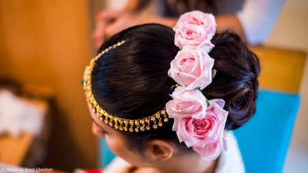 Stunning pink roses for bridal bun hairstyle