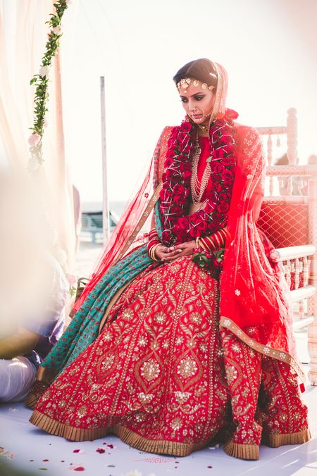 Photo of Red gota patti bridal lehenga with roses jaimala