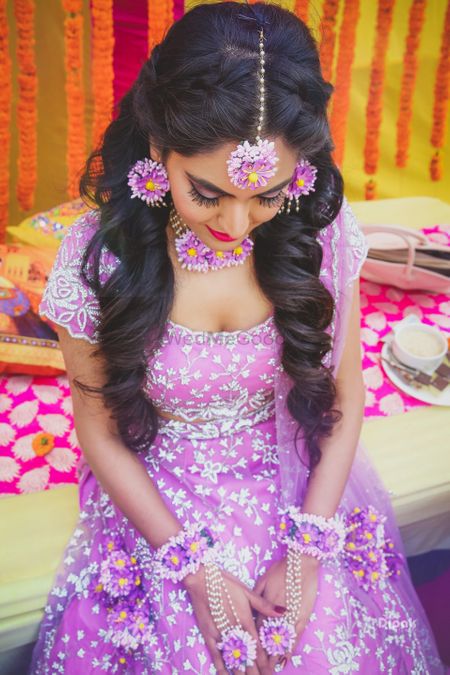Bride in lavender lehenga and floral jewellery