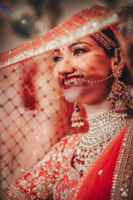 A happy bridal shot in beautiful gold jewellery. 