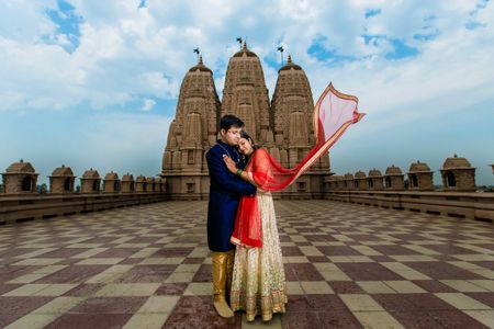 A couple pose for htie rpre-wedding shoot at a temple complex