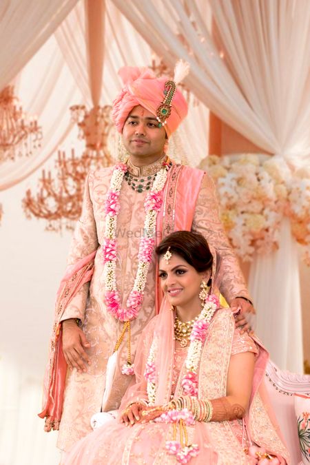 Bride and groom in pastel outfits for wedding 
