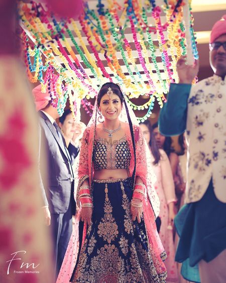 Bridal entry idea under colourful phoolon ka chadar 