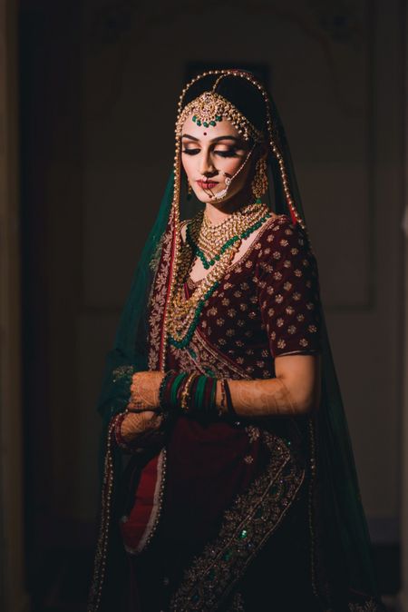 Bride with contrasting jewellery and deep lehenga 
