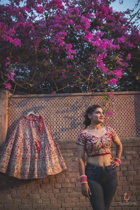 Photo of Bride in jeans with lehenga shot