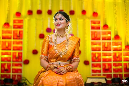 South indian bride in orange kanjivaram saree 