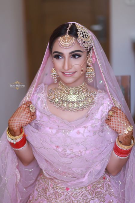 Bridal jewellery and makeup with light pink lehenga 