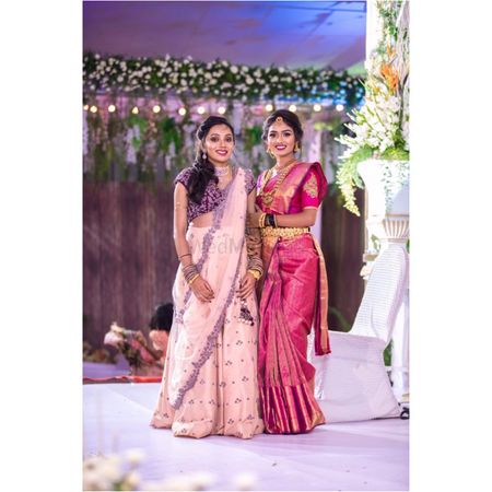 A south Indian bride in a pink kanjeevaram with her friend