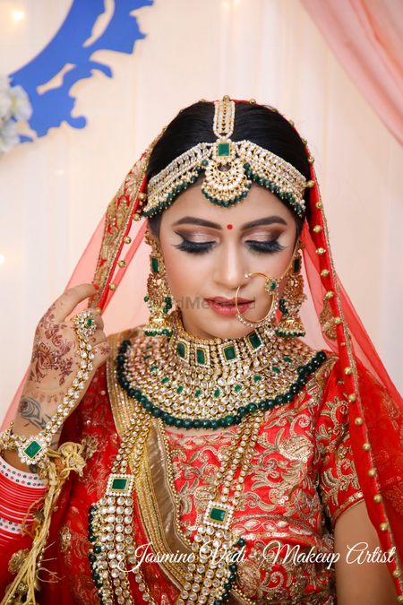 A bride in red and heavy jewellery
