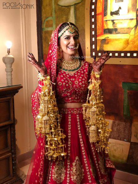 Bride in red happy wearing kaleere 