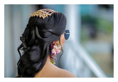 Mehendi hairdo with jewellery and floral earrings 