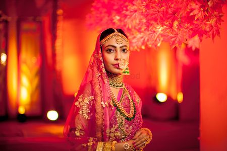 Red bridal portrait wearing Nath 