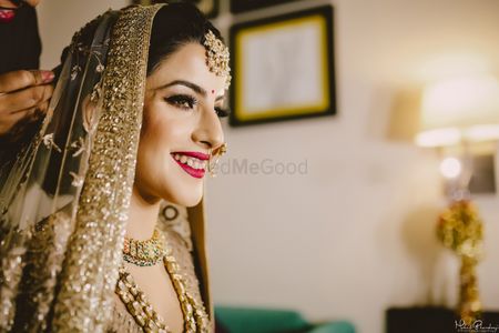 Bridal portrait in gold with red makeup 