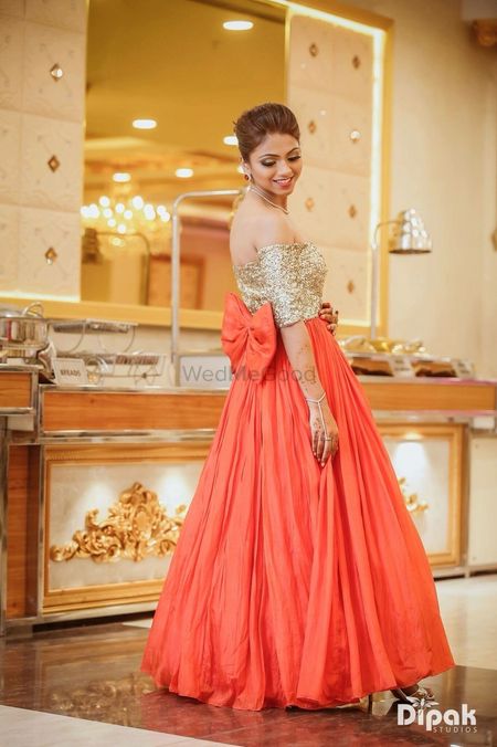 Photo of Orange and gold gown with bow design
