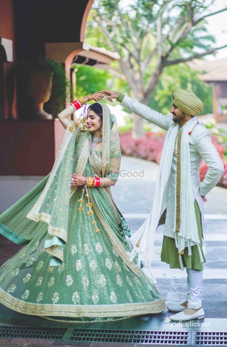 Photo of Couple dancing portrait in offbeat colour outfits