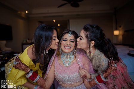 Cute bridesmaid kissing brides photo 