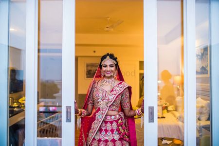 Photo of Red bridal lehenga with blue embroidery
