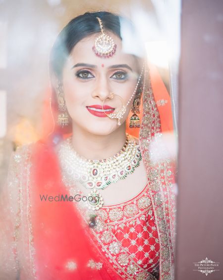 Photo of Reflection bridal portrait wth orange dupatta