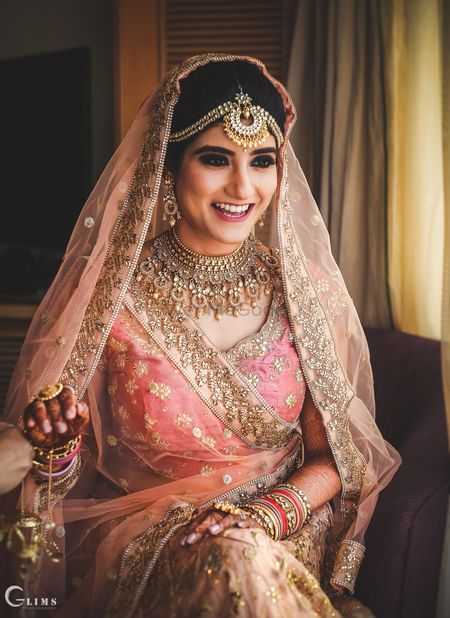 Bride in peach with statement bridal jewellery 