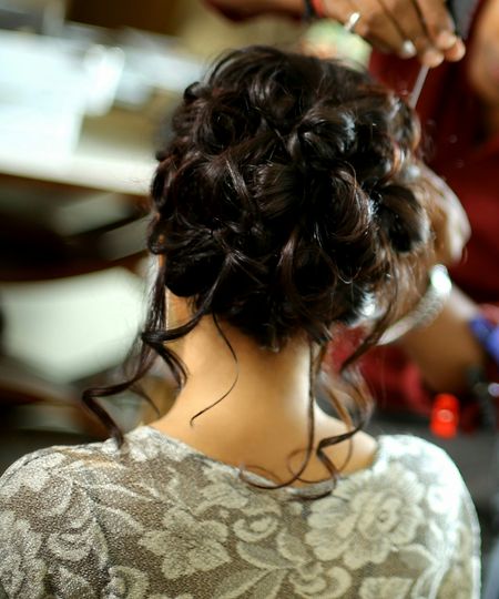 Engagement hairstyle bun with loose curls