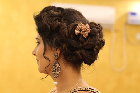 Braided bun with gold cloth roses