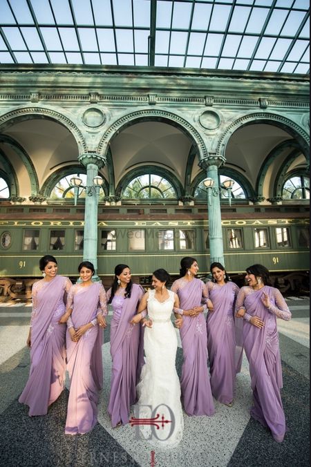 Photo of Bride with bridesmaids in lavender outfits