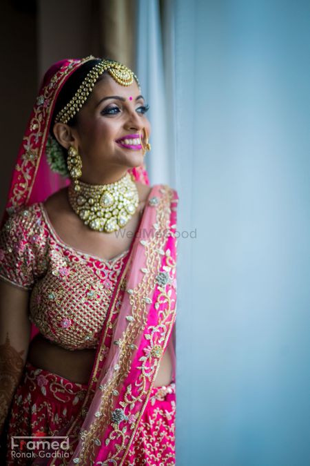 Happy bride in bright pink lehenga