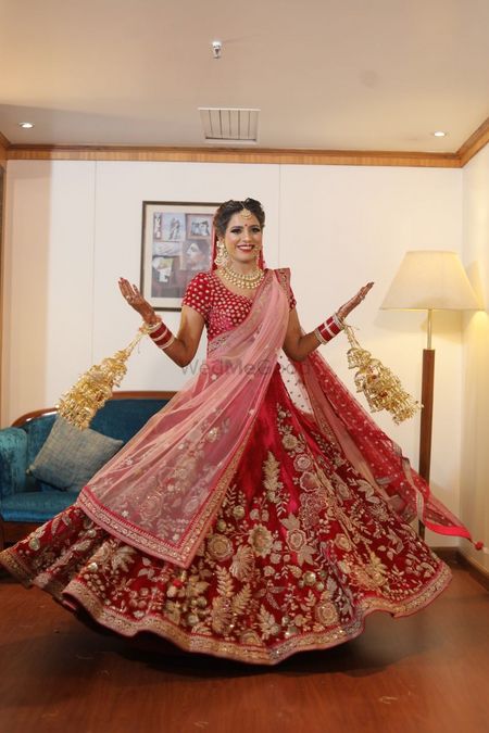 Twirling bride in red velvet lehenga 