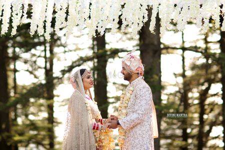 Photo of Jaimala shot in forest wedding with matching bride and groom