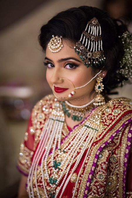 Photo of Bride wearing pearl and green bead jewellery