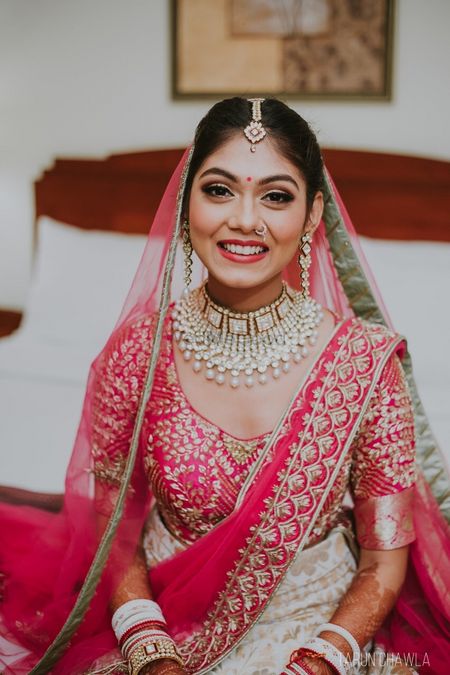 Photo of A bride smiles for the camera