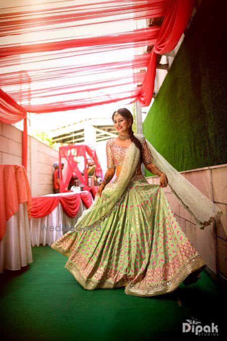 Happy bride shot in green mehendi lehenga 