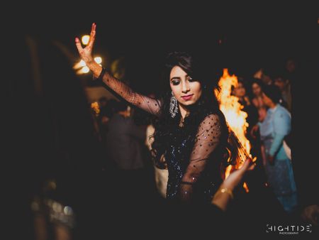 Bride dancing in black cocktail outfit 