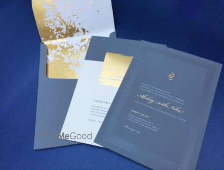 Photo of blue and gold wedding card