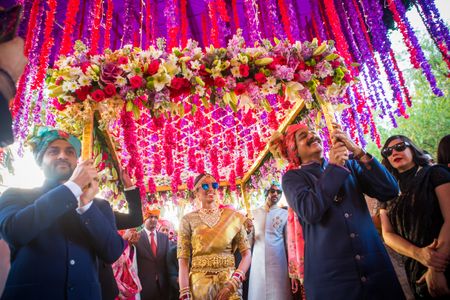 South indian bride enters under a phoolon ki chadar